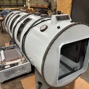 Industrial cylindrical machine in a workshop setting.